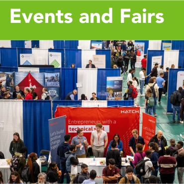 Students gathering around booths at a job fair.